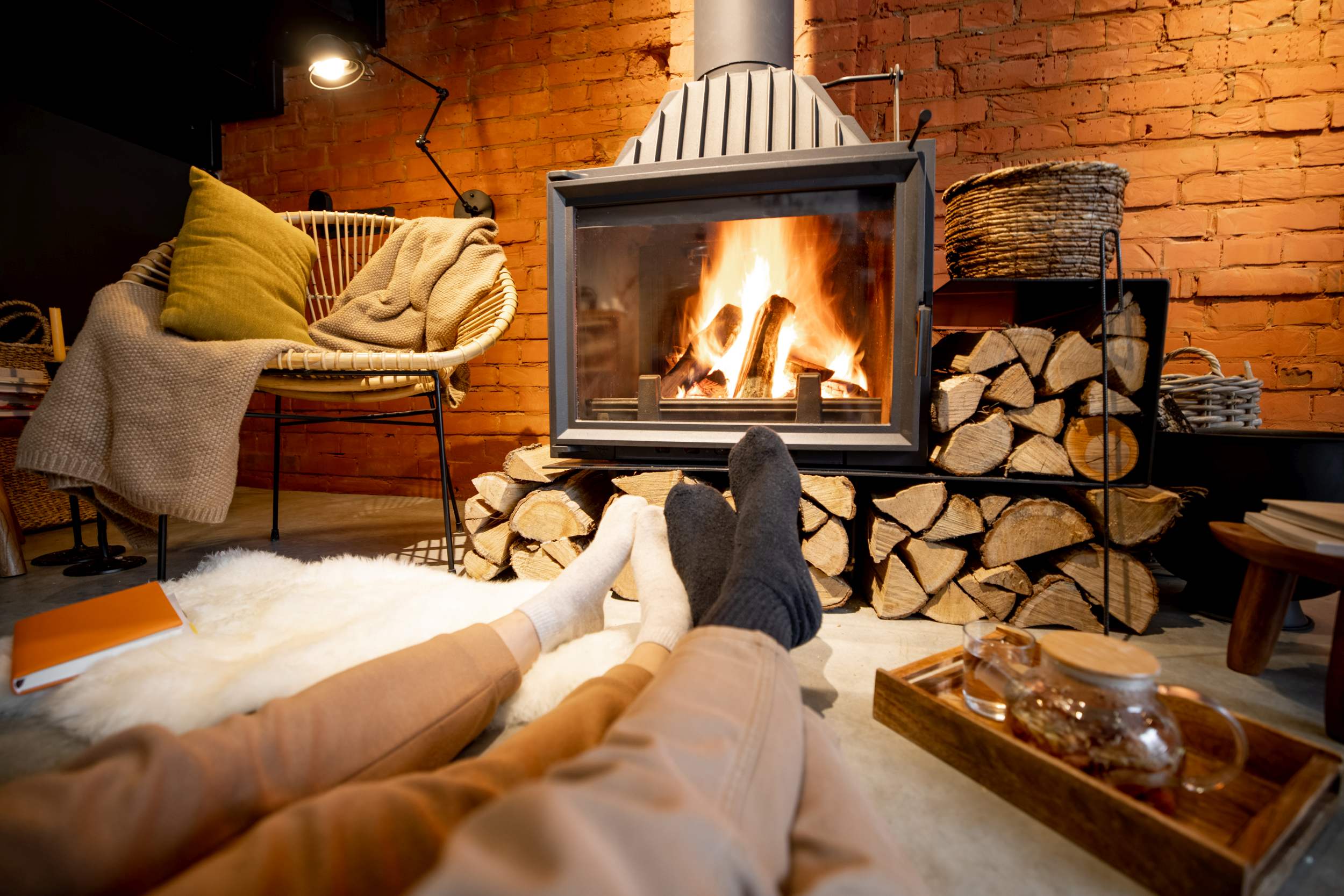 Couple lying by the burning fireplace at home